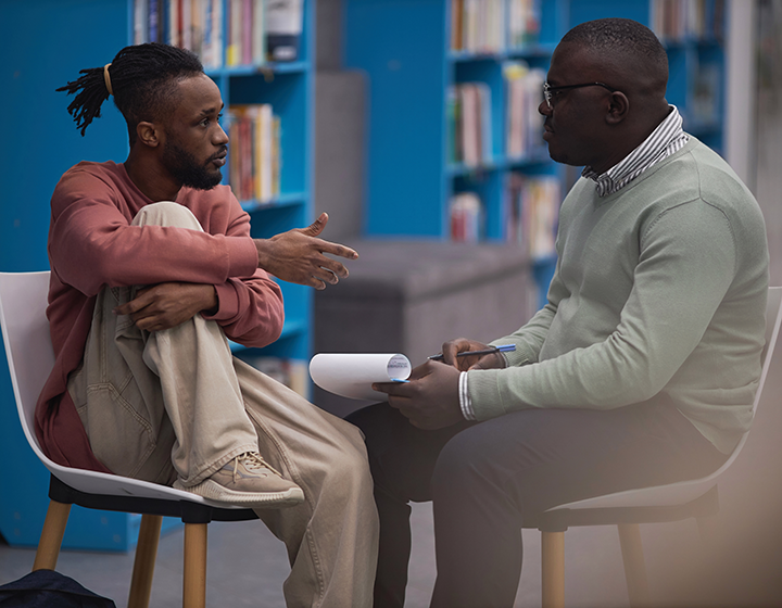 A student speaks with a school psychologist or counselor. Image source: Shutterstock.